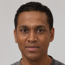 Joyful black adult male with short  black hair and brown eyes